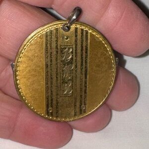 Vintage gold monogrammed cigar cutter pendant